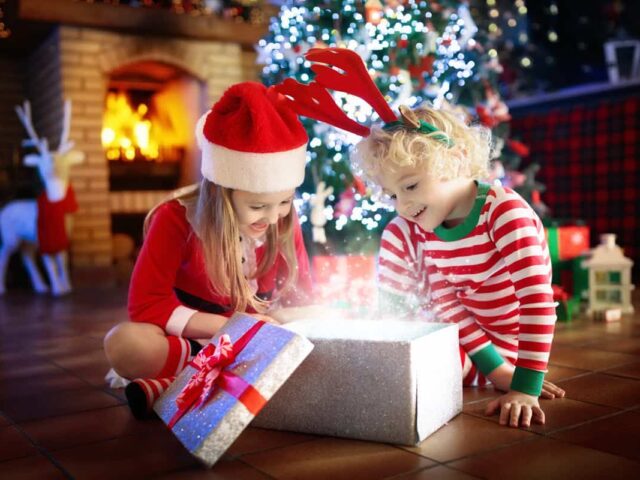 Bambini che aprono i regali di Natale